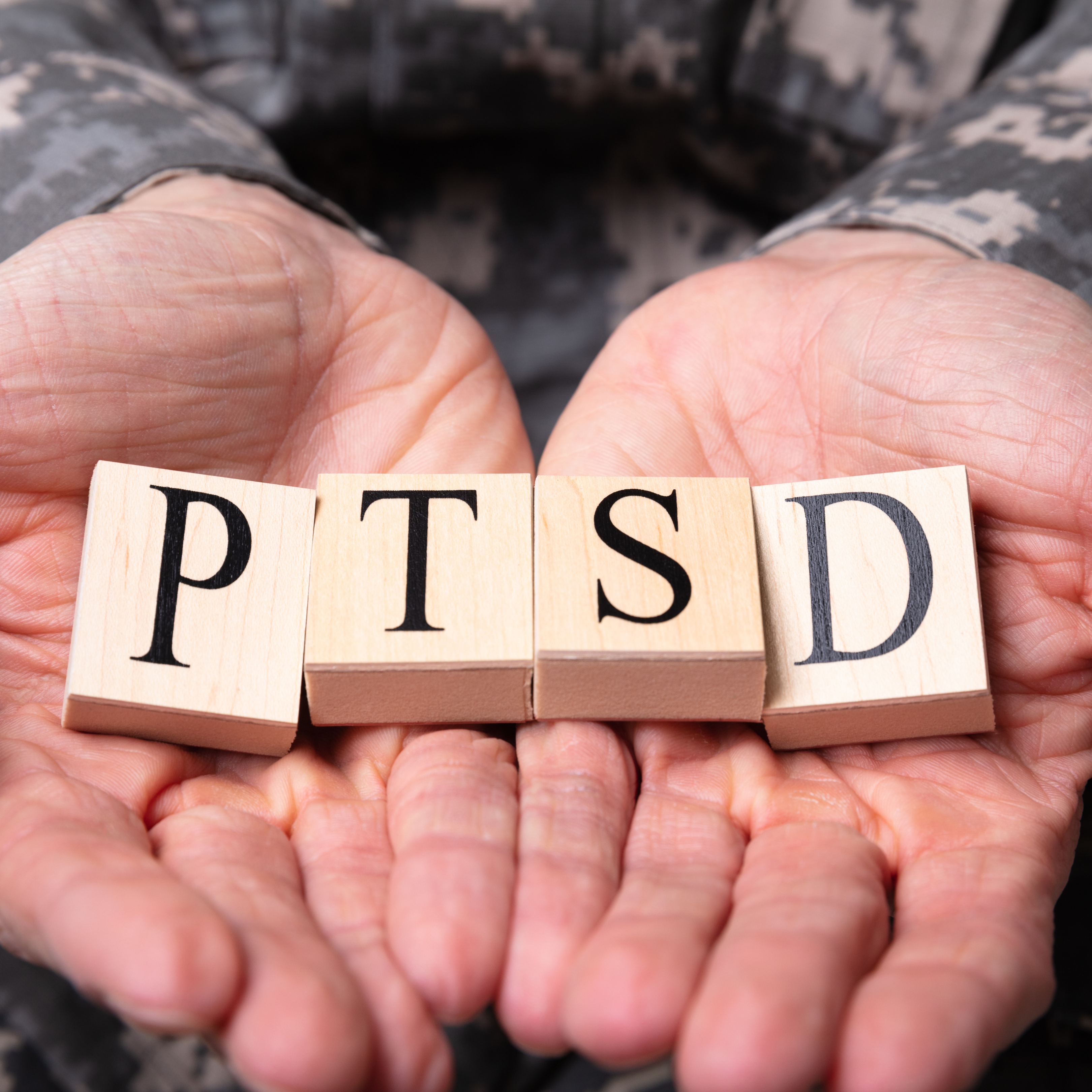 hands holding ptsd blocks